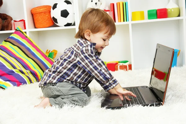 Cute little boy and notebook in room — Stock Photo, Image