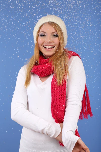 Young beautiful woman with snow on blue background — Stock Photo, Image