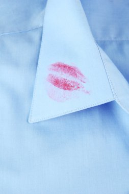 Lipstick kiss on shirt collar of man, close up clipart