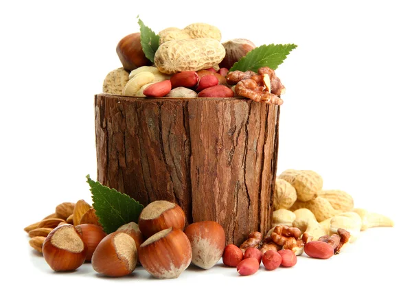 Assortment of tasty nuts with leaves in wooden vase, isolated on white — Stock Photo, Image