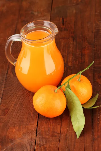 Full kannan av tangerine juice, på trä bakgrund — Stockfoto