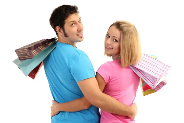 Casal jovem compras e segurando muitos sacos de compras isolados no branco — Fotografia de Stock