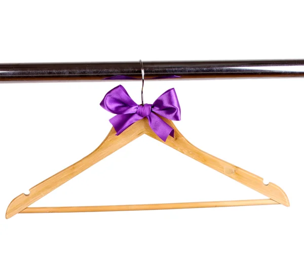 Beautiful purple bow hanging on wooden hanger isolated on white — Stock Photo, Image