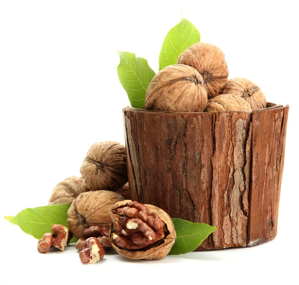 Nueces con hojas verdes en jarrón de madera, aisladas en blanco —  Fotos de Stock