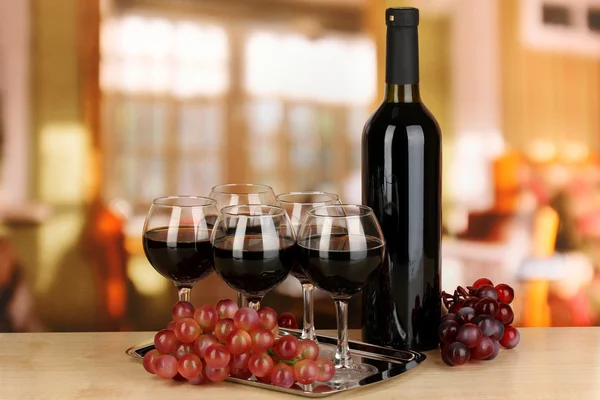 Red wine in glass and bottle on room background — Stock Photo, Image