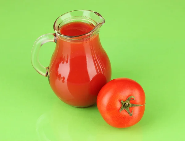 Full jug of tomato juice, on color background — Stock Photo, Image