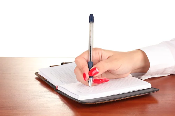 Hand ondertekening in notitieblok op houten tafel geïsoleerd op wit — Stockfoto