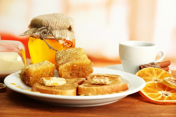 White bread toast with honey and cup of coffee on wooden table — Stock Photo, Image