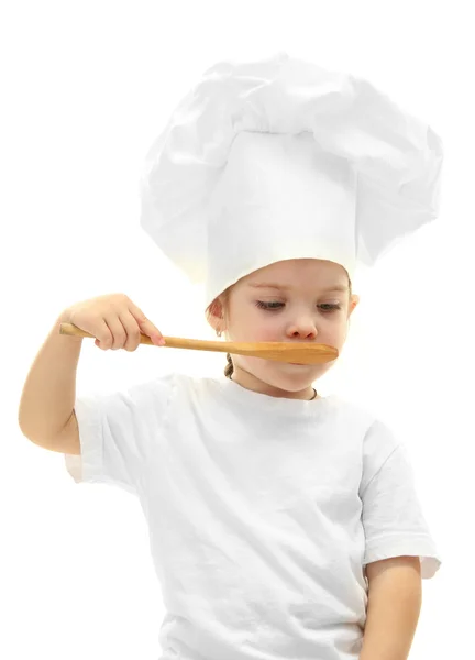 Bambina in cappello da chef con cucchiaio, isolata su bianco — Foto Stock