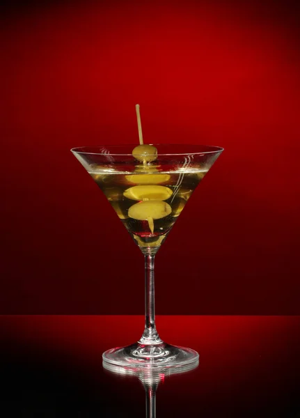 Martini glass and olives on dark background — Stock Photo, Image