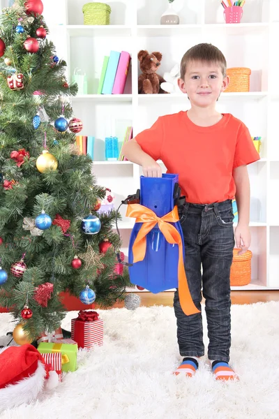 Little boy stands near Christmas tree with flippers Royalty Free Stock Photos