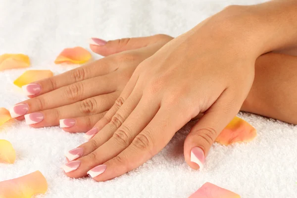 Woman's hands on white terry towel, close-up — Stock Photo, Image