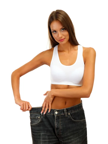 Belle jeune femme avec de gros jeans, isolée sur blanc — Photo