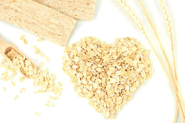 Heart shape made from oat flakes with oat biscuits and ears isolated on white — Stock Photo, Image
