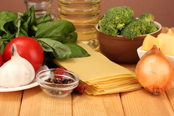 Vegetarian lasagna ingredients on brown background — Stock Photo, Image