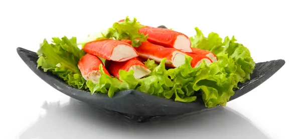 Palitos de cangrejo con hojas de lechuga y limón en plato aislado en blanco —  Fotos de Stock