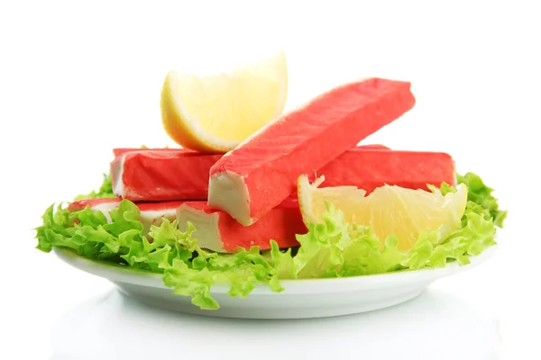 Crab sticks with lettuce leaves and lemon on plate isolated on white — Stock Photo, Image