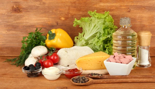 Ingredients for pizza on brown background — Stock Photo, Image