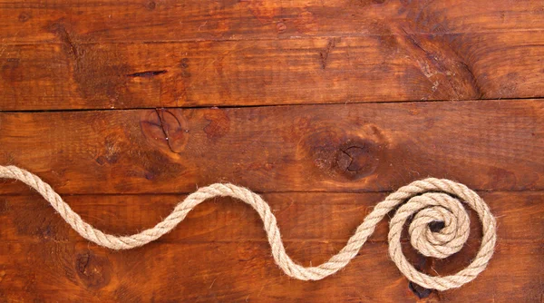 Frame composed of rope on wooden background — Stock Photo, Image