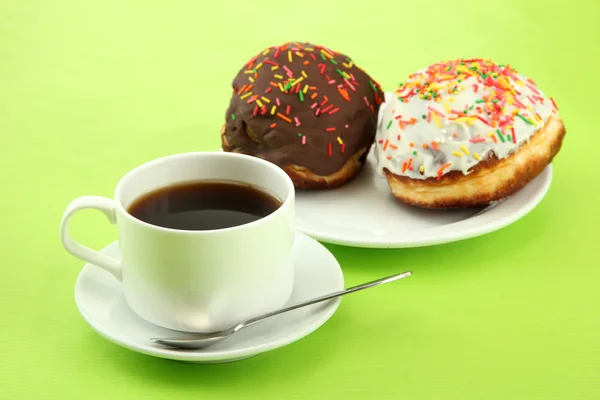 Tasty donuts on color plate on color background — Stock Photo, Image