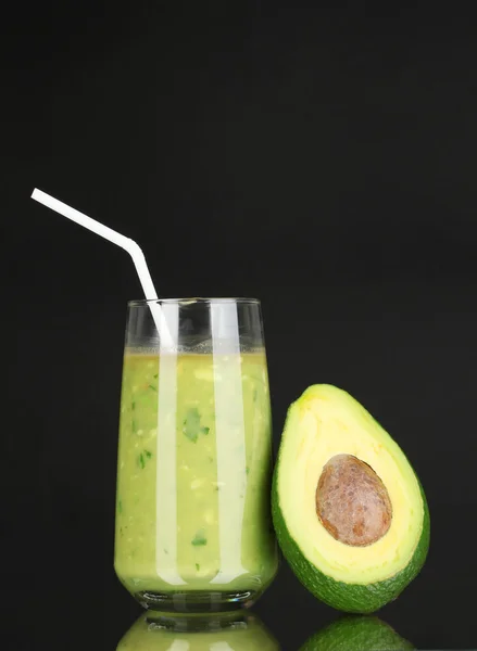 Useful fresh avocado and half avocado on black background — Stock Photo, Image