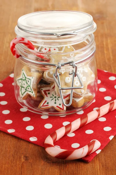 Christmas treats in bank on wooden table close-up — Stock Photo, Image