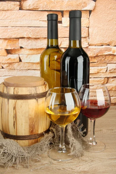 Композиція з вина та дерев'яної бочки на столі на фоні цегляної стіни — стокове фото