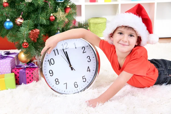 Little boy with clock in anticipation of New Year Stock Picture