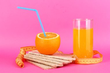 Olgun portakal, loafs ve suyu pembe arka plan diyet sembolü olarak