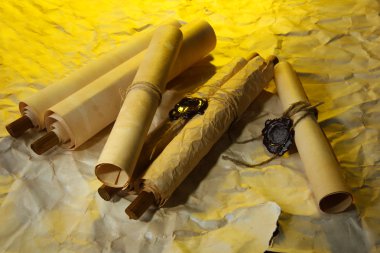 Old scrolls, on brown paper background clipart