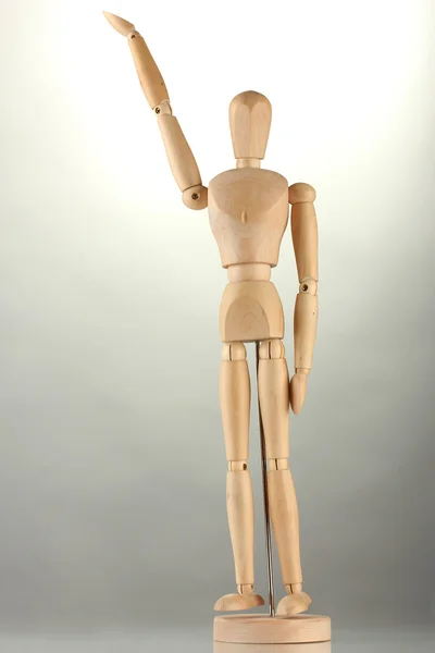 Wooden mannequin, on grey background — Stock Photo, Image