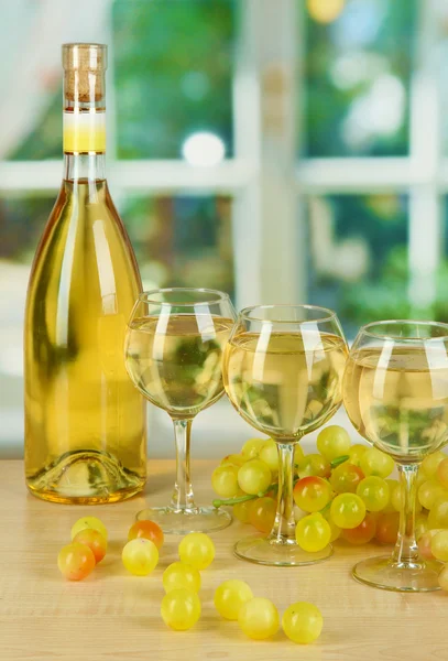 White wine in glass with bottle on window background — Stock Photo, Image