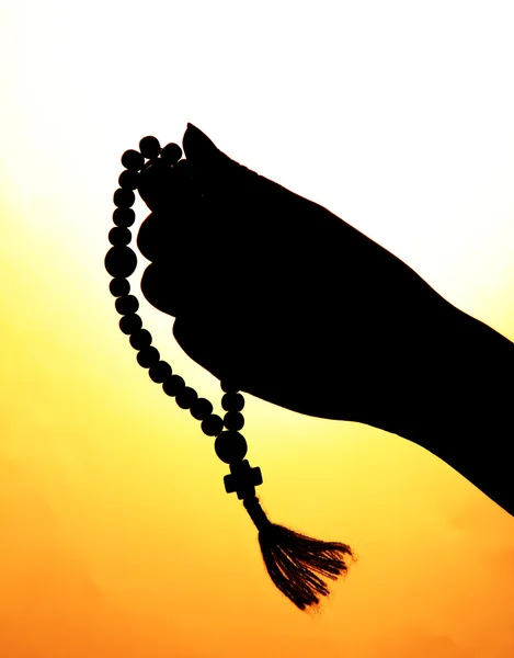 Female hands with rosary, on beige background — Stock Photo, Image