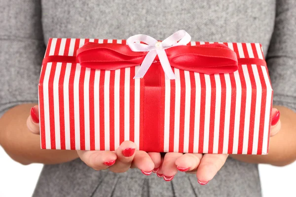 Woman holds box with gift on white background close-up — Stockfoto