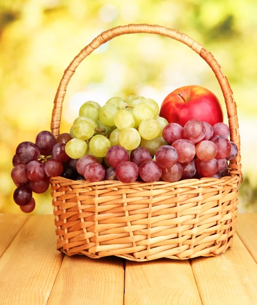 Grape in basket on wooden table — Stock Photo, Image