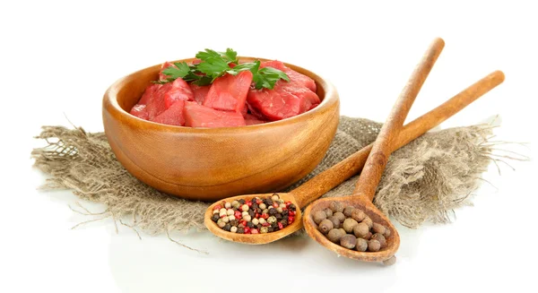 Raw beef meat in bowl with herbs and spices isolated on white — Stock Photo, Image