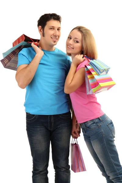 Joven pareja de compras y la celebración de muchas bolsas de compras aisladas en blanco — Foto de Stock