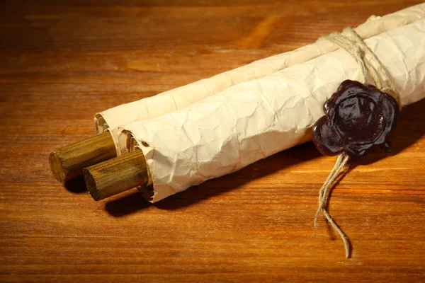 Old scroll, on wooden background — Stock Photo, Image