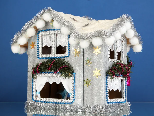 Dekoriertes Weihnachtshaus auf blauem Hintergrund — Stockfoto