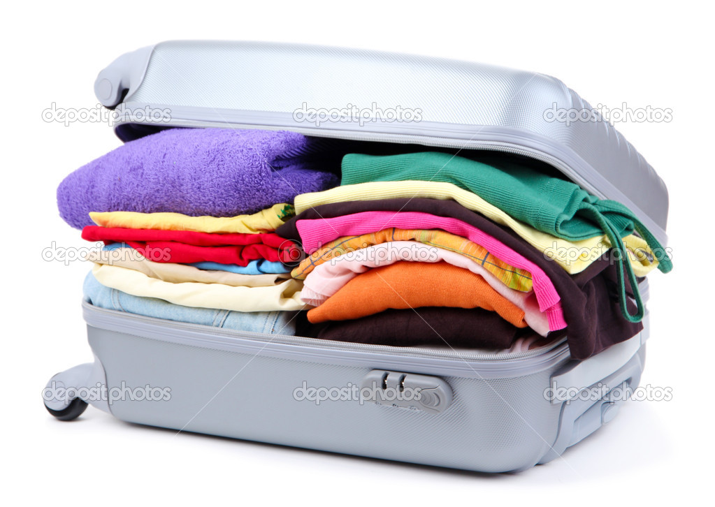 Closed silver suitcase with clothing isolated on white