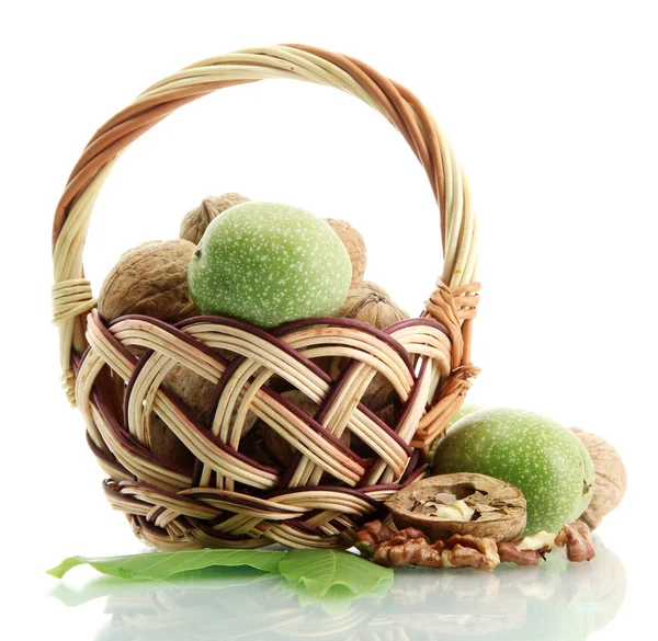 Walnuts with green leaves in basket, isolated on white — Stock Photo, Image