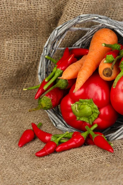 Свежие красные овощи на фоне мешковины — стоковое фото