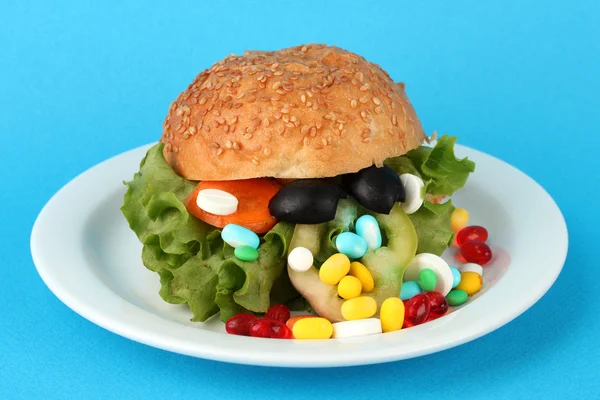 Conceptual image for nutritional care:assorted vitamins and nutritional supplements in bun.On color background — Stock Photo, Image