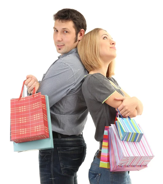 Joven pareja de compras y la celebración de muchas bolsas de compras aisladas en blanco — Foto de Stock