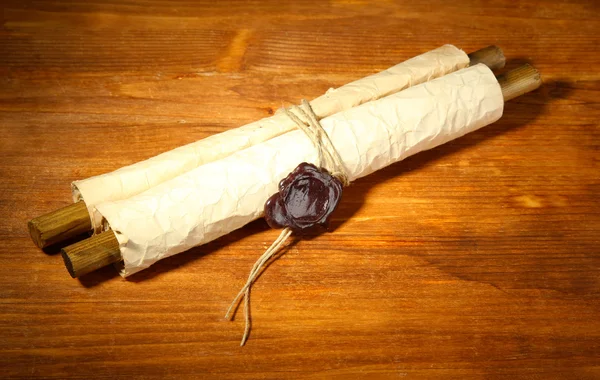 Old scroll, on wooden background — Stock Photo, Image