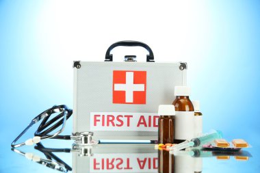 First aid box, on blue background clipart