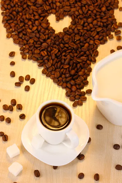 A cup of strong coffee and sweet cream on wooden table close-up — Stock Photo, Image