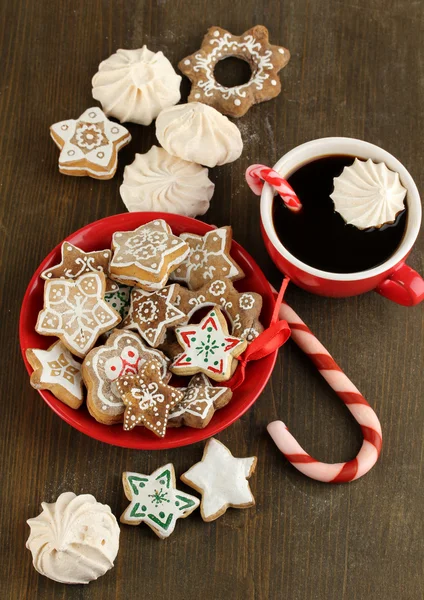 Christmas treats on plate and cup of coffe on wooden table close-up — Stock Photo, Image