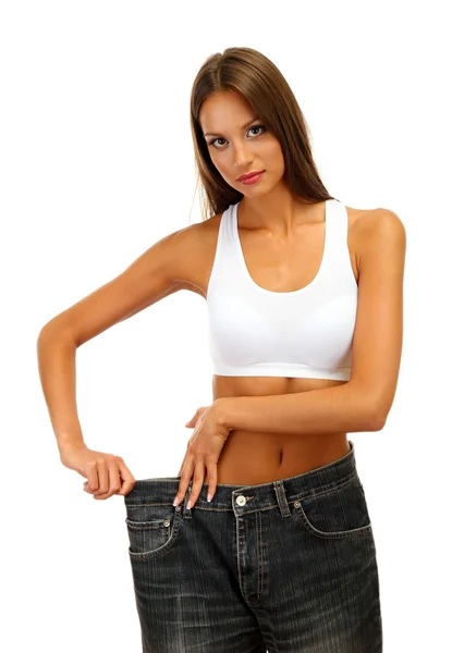 Belle jeune femme avec de gros jeans, isolée sur blanc — Photo