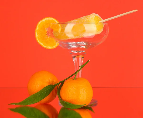 Yellow fruit juice ice in vase on red background — Stock Photo, Image